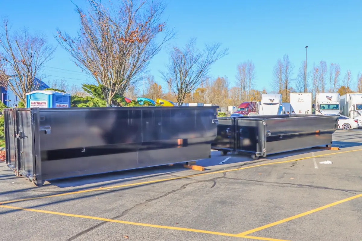Professional dumpster rental service with roll-off container on residential driveway in Collingswood